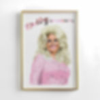 A portrait of Dolly Parton, country music singer and cowgirl. The art hangs in a thin, gold frame on a white wall.