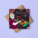 A square, black illustrated greeting card of a DJ on the decks. The card rests on a brown envelope with lilac background.