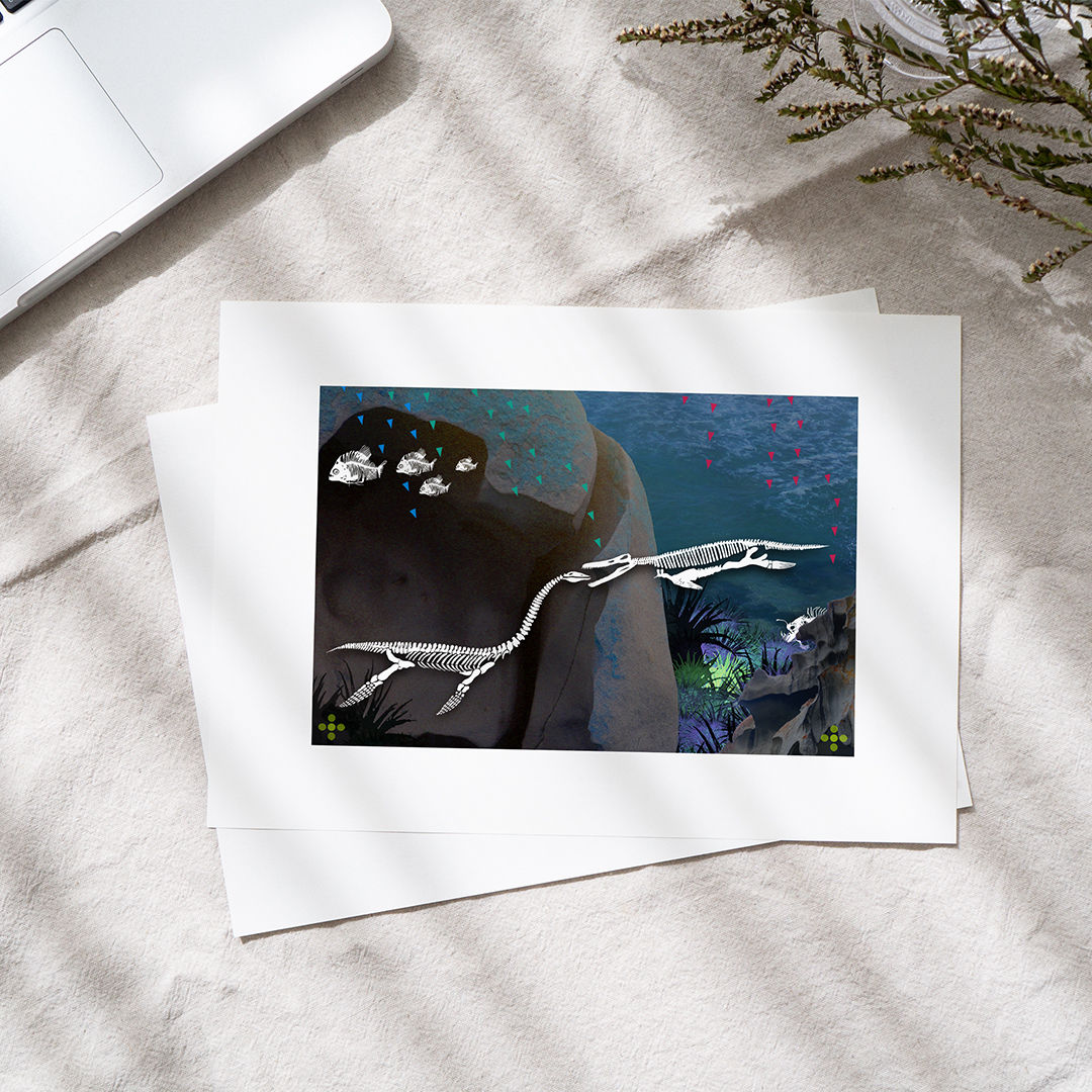 A limited edition art print of marine dinosaurs with white border, resting on a table with a laptop and plants.