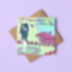 A mint green illustrated Mother's Day card of an elegant mum The card rests on a brown envelope and lilac background.