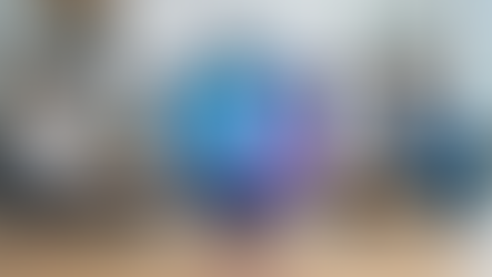 A security shield with a glowing digital brain and padlock on a desk in a modern office setting.