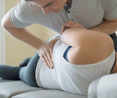 Chiropractic adjustments is being given to a women by a chiropractor