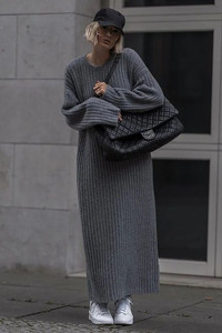 Woman wearing a great knit dress, page boy cap and sneakers