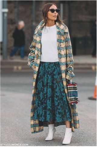 Street style woman wearing clashing prints outside a fashion show