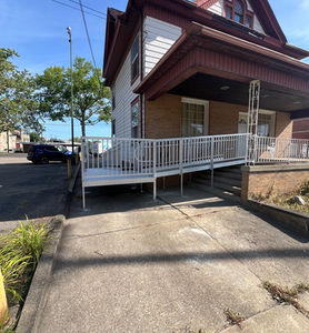Aluminum modular wheelchair ramps installed at a home porch.