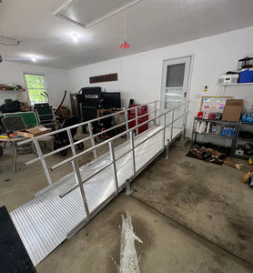 Aluminum modular wheelchair ramps installed in a garage.