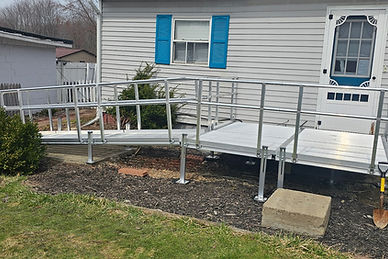 Aluminum modular wheelchair ramps installed at a home entry.