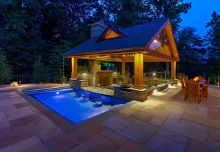 Beautifully lit pool and gazebo at night