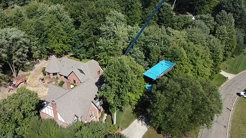 Aerial view of a house and pool, showcasing site improvement expertise.