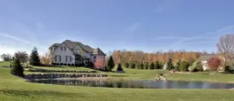 House and pond on a property demonstrating site improvement expertise.