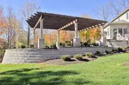 Backyard pergola and retaining wall, showing site improvement expertise.