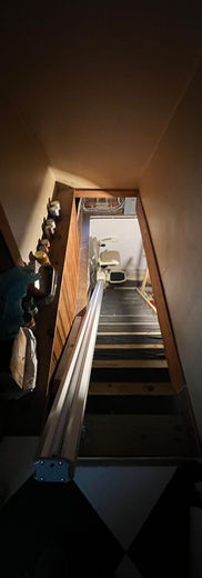 Wooden staircase leading up to a bright landing