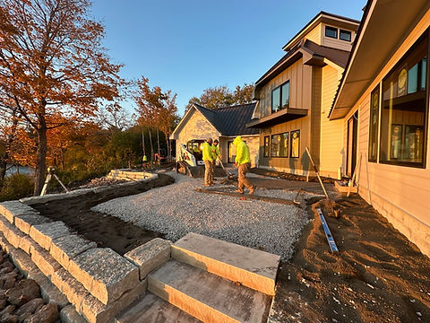 Workers constructing a patio and retaining wall.