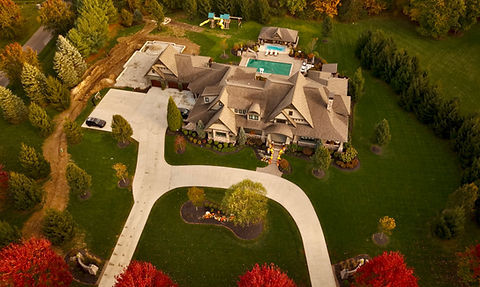 Aerial view of a large, improved property with pool