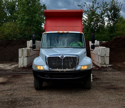 Gray dump truck for site improvement