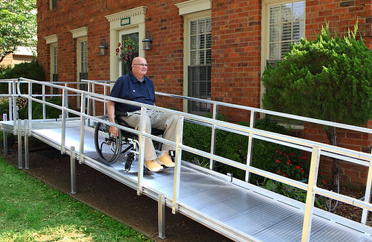 Man in wheelchair on ramp for independent living home remodel