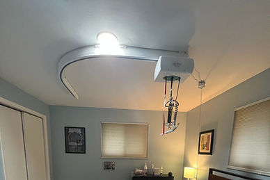 Ceiling track for mobility transfer aid systems in a bedroom.