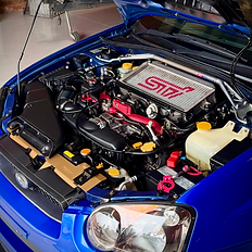 Blue car engine bay with STI engine