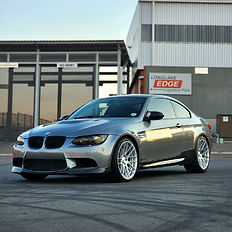 Silver BMW M3 coupe parked in front of a building