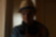 Defocus young woman take photography in mirror reflection. Millennial woman in hat. Dark b
