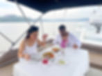 A man and woman enjoying a delicious meal onboard a luxury yacht in Goa