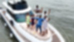 A group of friends enjoying themselves on the sundeck of a luxury yacht in goa