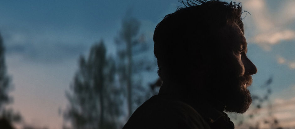 man looking out into the sunset