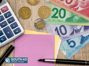 Canadian bills and coins with a calculator. Cost of spray foam with South 40 Spray Foam SK