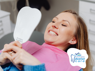 dental patient checking her teeth in the mirror. Clearview Dental is your dentist with direct billing in Red Deer.
