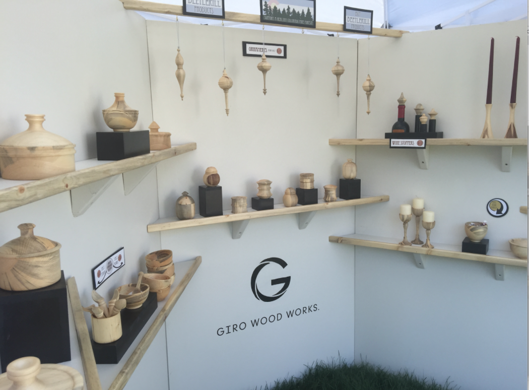 Created a white structure to display wood shelving and pieces under the tent frame