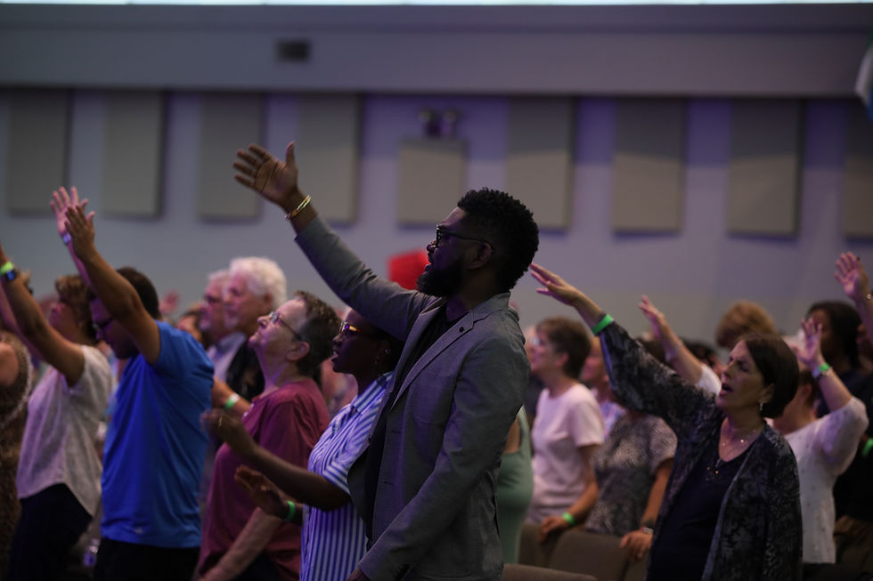 Attendees worshipping at The Happening, a gathering at Shekinah Christian Church