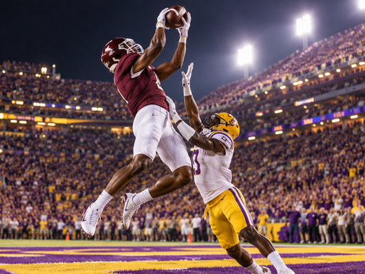 Texas A&M receiver high-points a football against an LSU defender in the end zone at night