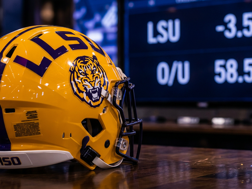 LSU helmet beside a college football odds board for the 2026 LSU vs. Ole Miss betting line article
