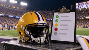 Gold football helmet beside an SEC-style player availability status card before LSU plays Ole Miss in 2026