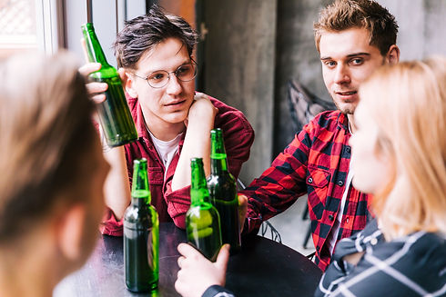 group-friends-sitting-together-holding-green-beer-bottles.jpg