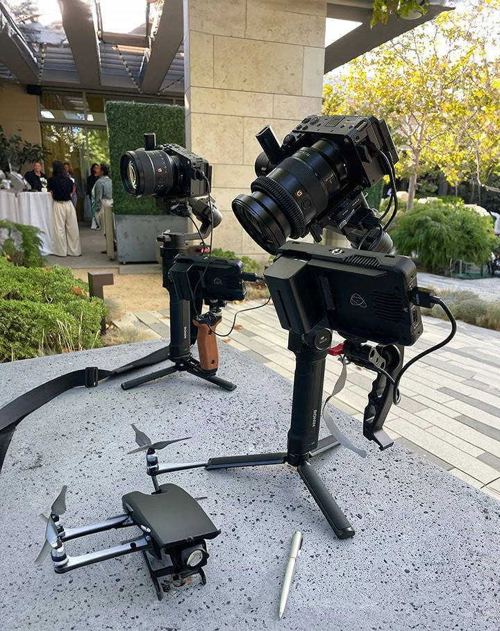 Close-up of two Sony cameras mounted on handheld gimbals with Atomos external monitors, prepped for cinematic event coverage in an outdoor venue setting.