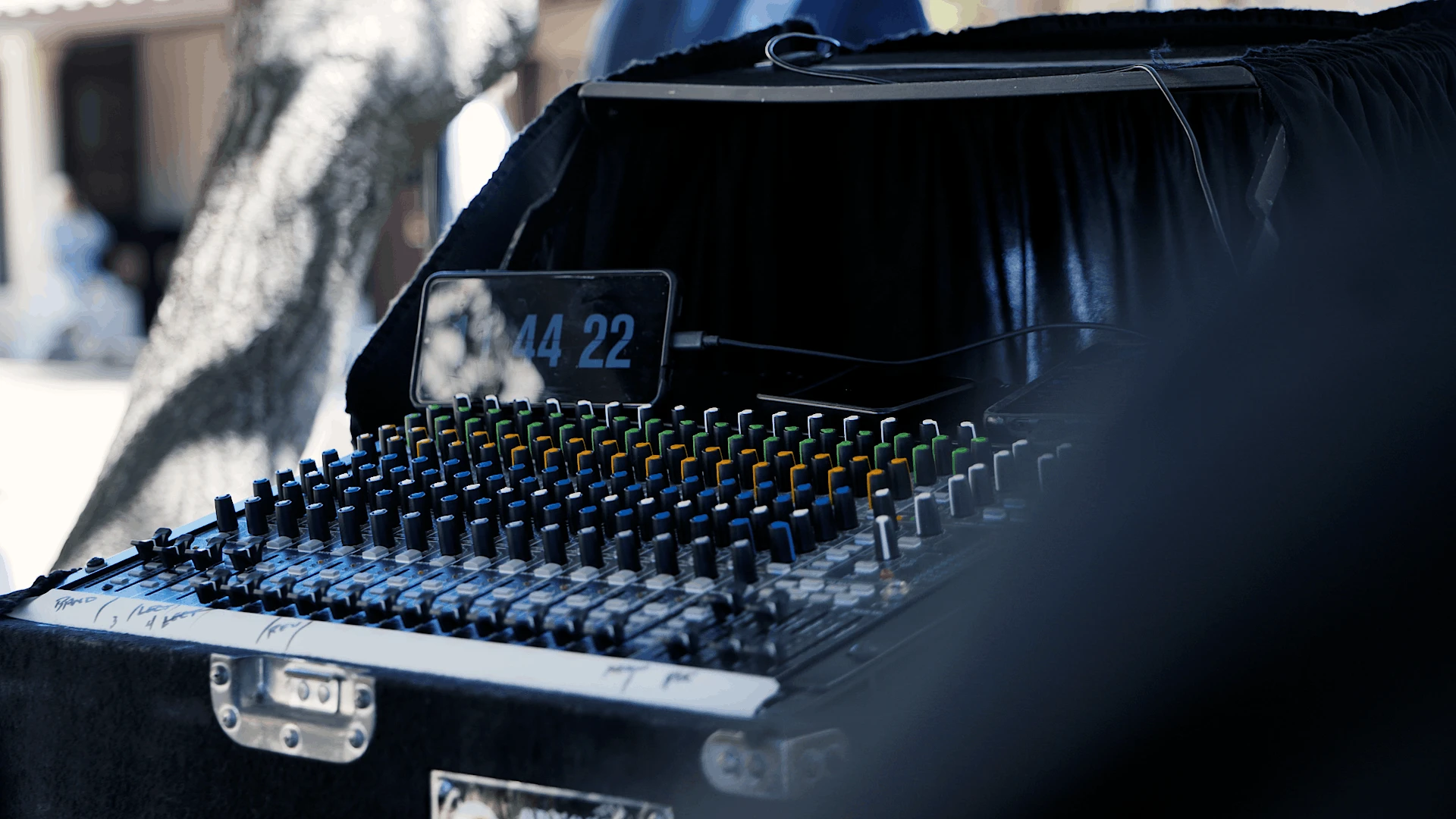 Audio mixing console used to capture a clean sound feed for an outdoor commencement live stream.
