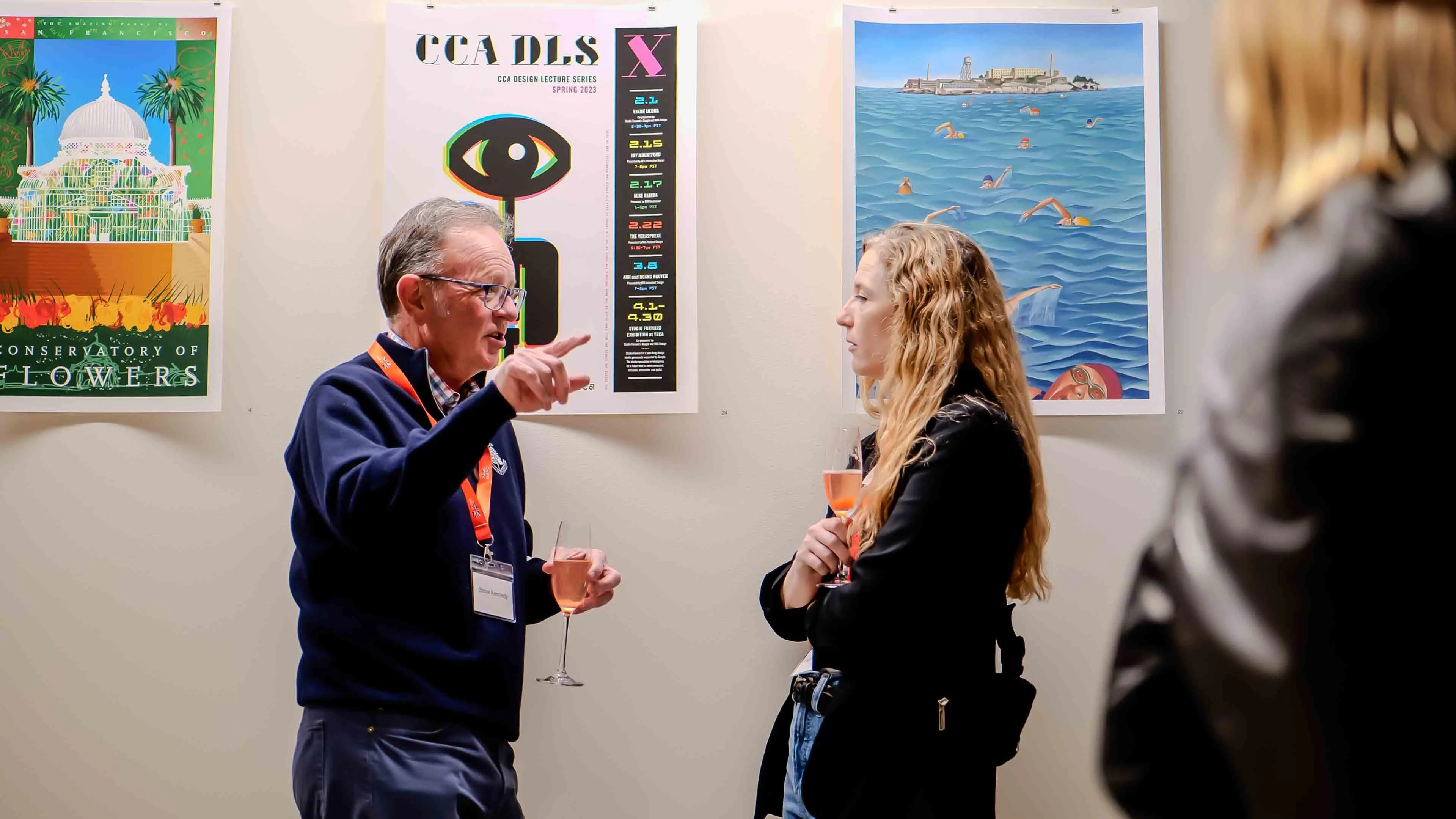 Guests enjoying conversation and wine in front of San Francisco–themed poster art during the Virgin Atlantic and British Consulate event at the Center for Architecture + Design.