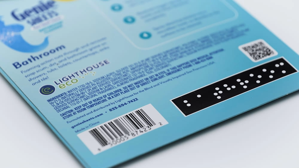 Close-up studio product shot of the back label on a Genie’s Sheets bathroom cleaner package, showing instructions, barcode, and QR code on a white background.