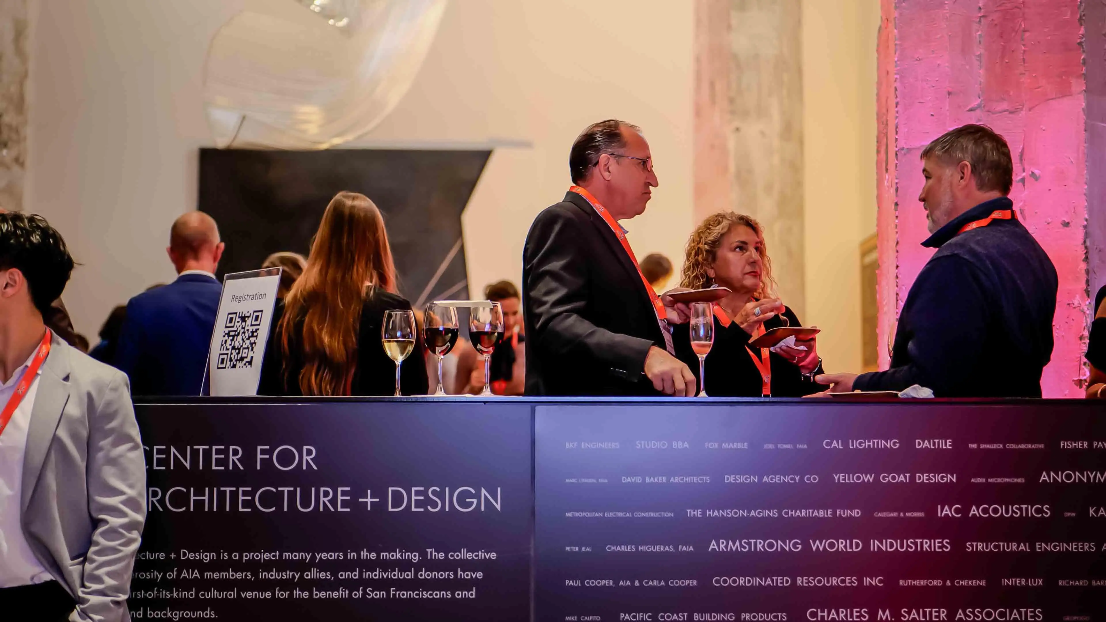 Guests enjoying drinks and conversation at the Center for Architecture + Design during the Virgin Atlantic and British Consulate celebration event in San Francisco, with the venue’s donor wall in the foreground.