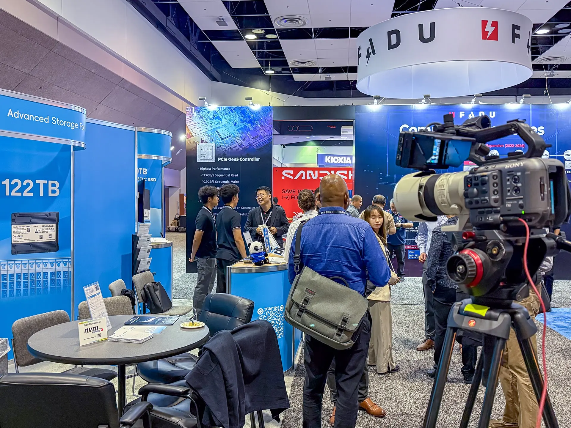 Professional videographer filming Dapustor booth at FMS 2025, Santa Clara Convention Center, capturing product displays, team interactions, and trade show engagement.