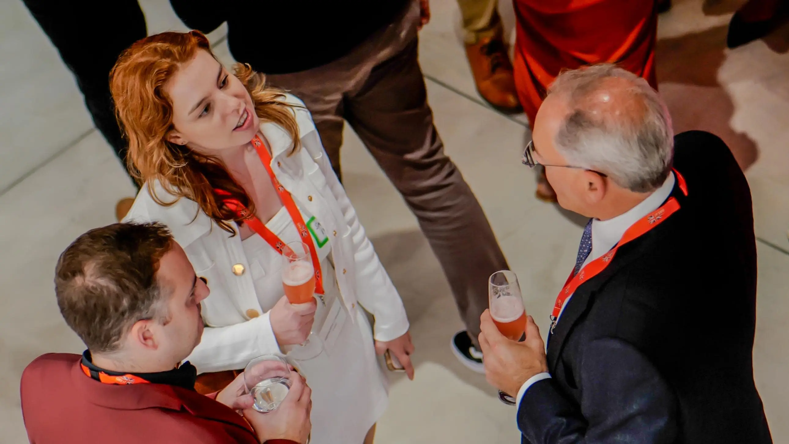 Guests engaged in conversation with drinks in hand during the Virgin Atlantic and British Consulate 30-year celebration event at the Center for Architecture + Design in San Francisco.