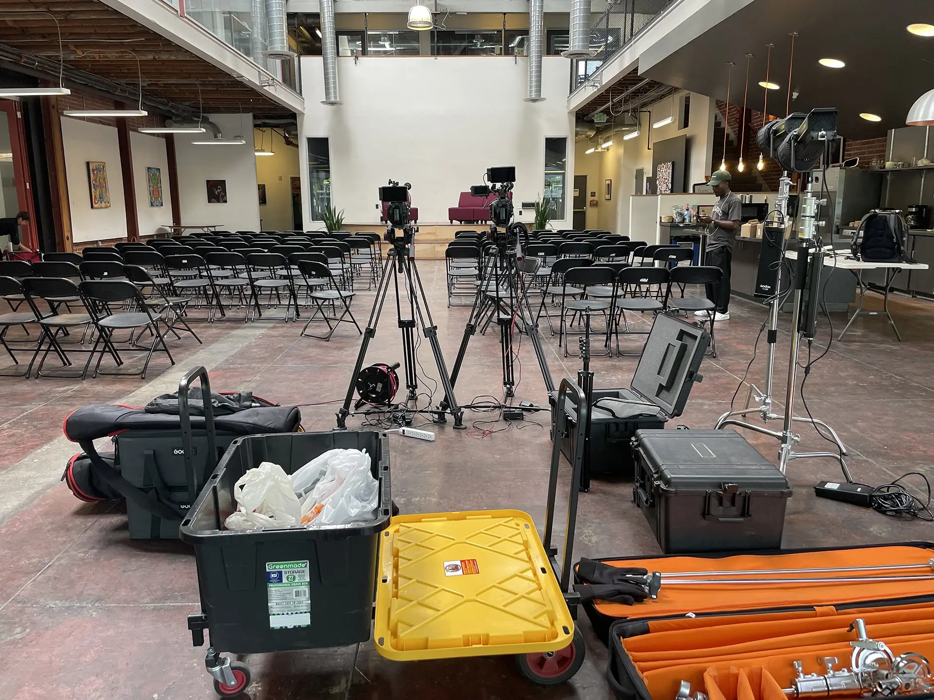Video production gear setup for the Black Political Power Tour – Oakland at Oakstop, showing camera tripods, lighting equipment, and cases before audience arrival.