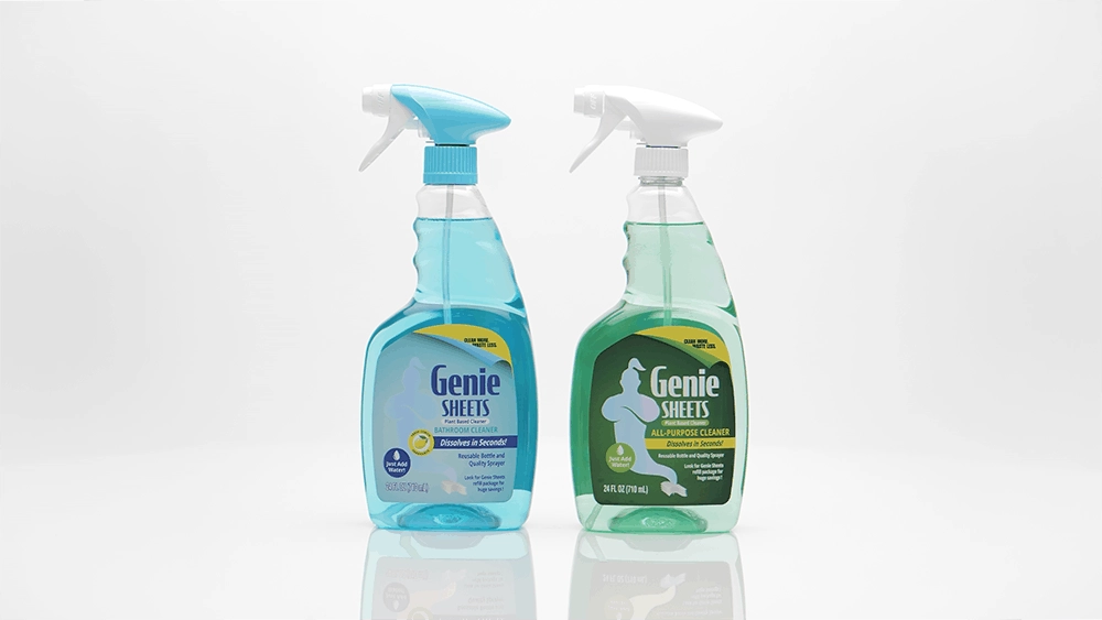 Studio product photo of Genie’s Sheets all-purpose cleaner packaging beside green cleaning sheets on a white background.