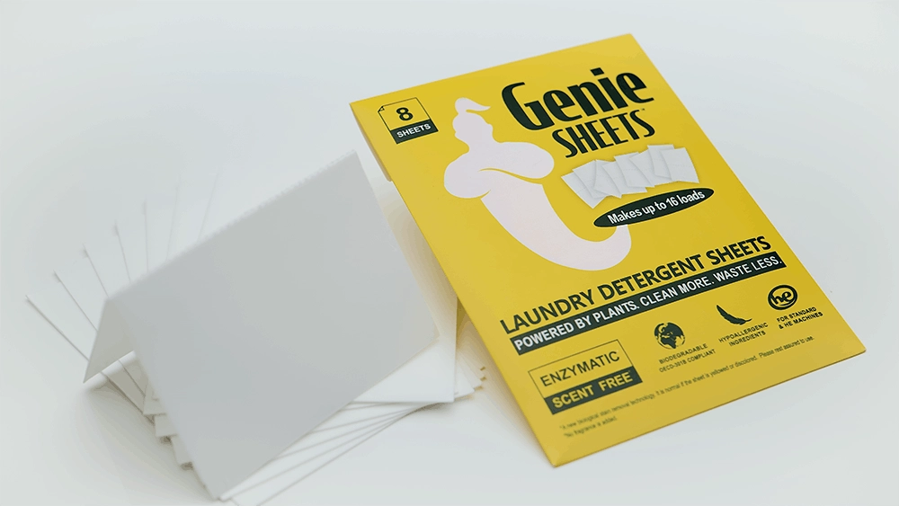 Studio product image of Genie’s Sheets laundry detergent sheet packaging with folded white detergent sheets on a white background.