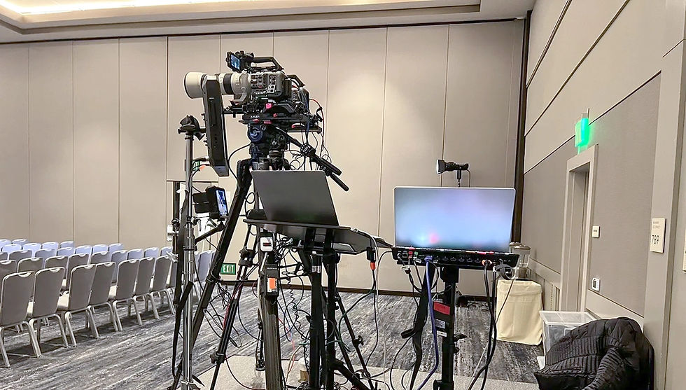 Multi-camera interview setup with lights and tripods in an indoor production space