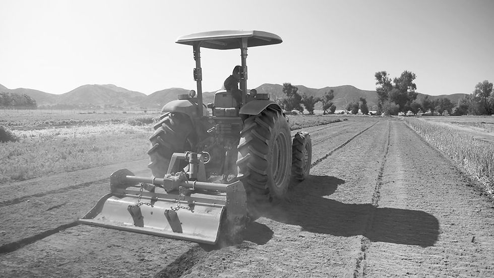 Screenshot from a promotional video featuring a tractor operating on an agricultural farm, produced by Bidar Video.