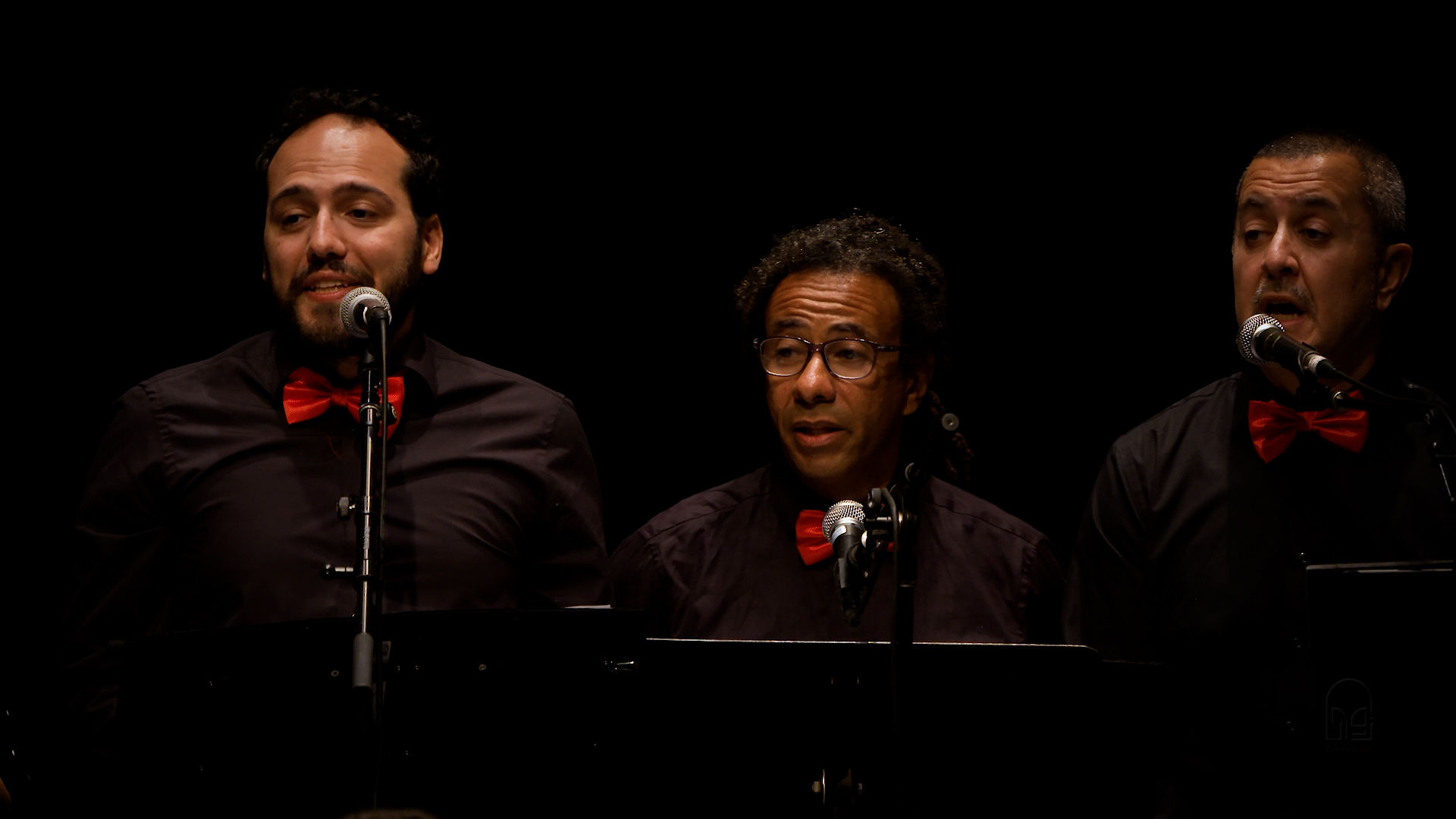 Three arabic men singing in chorus