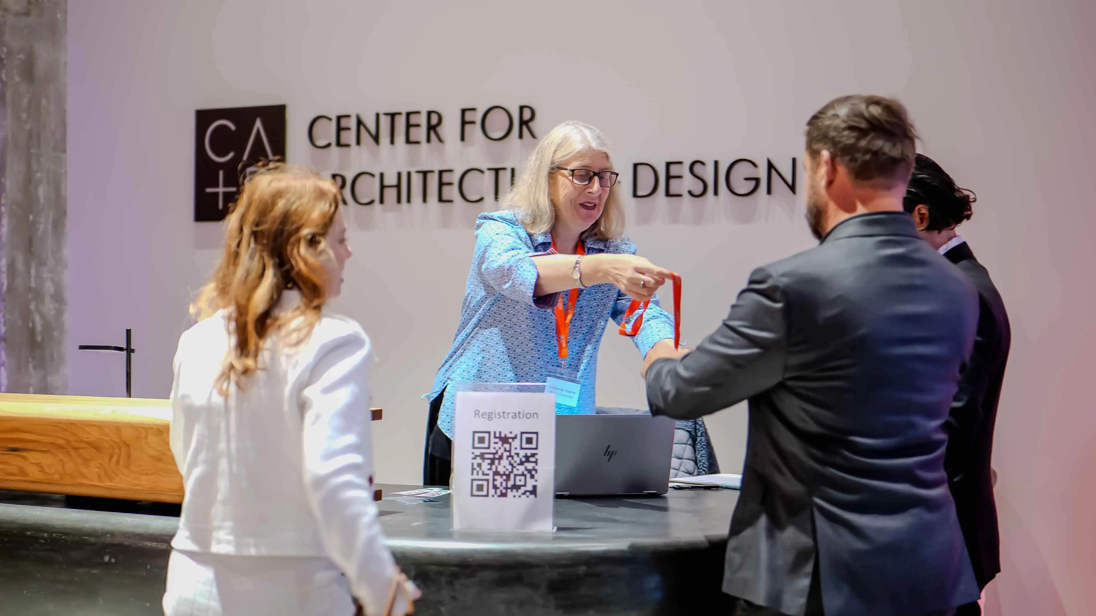 Event registration desk at the Center for Architecture + Design in San Francisco, with staff welcoming guests and distributing badges for the Virgin Atlantic and British Consulate event.