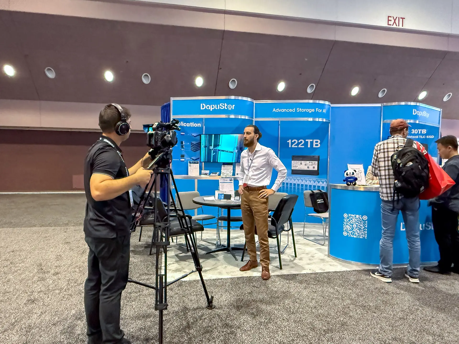Saboor Bidar recording Dapustor representative giving an on-camera statement at FMS 2025 booth, Santa Clara Convention Center.